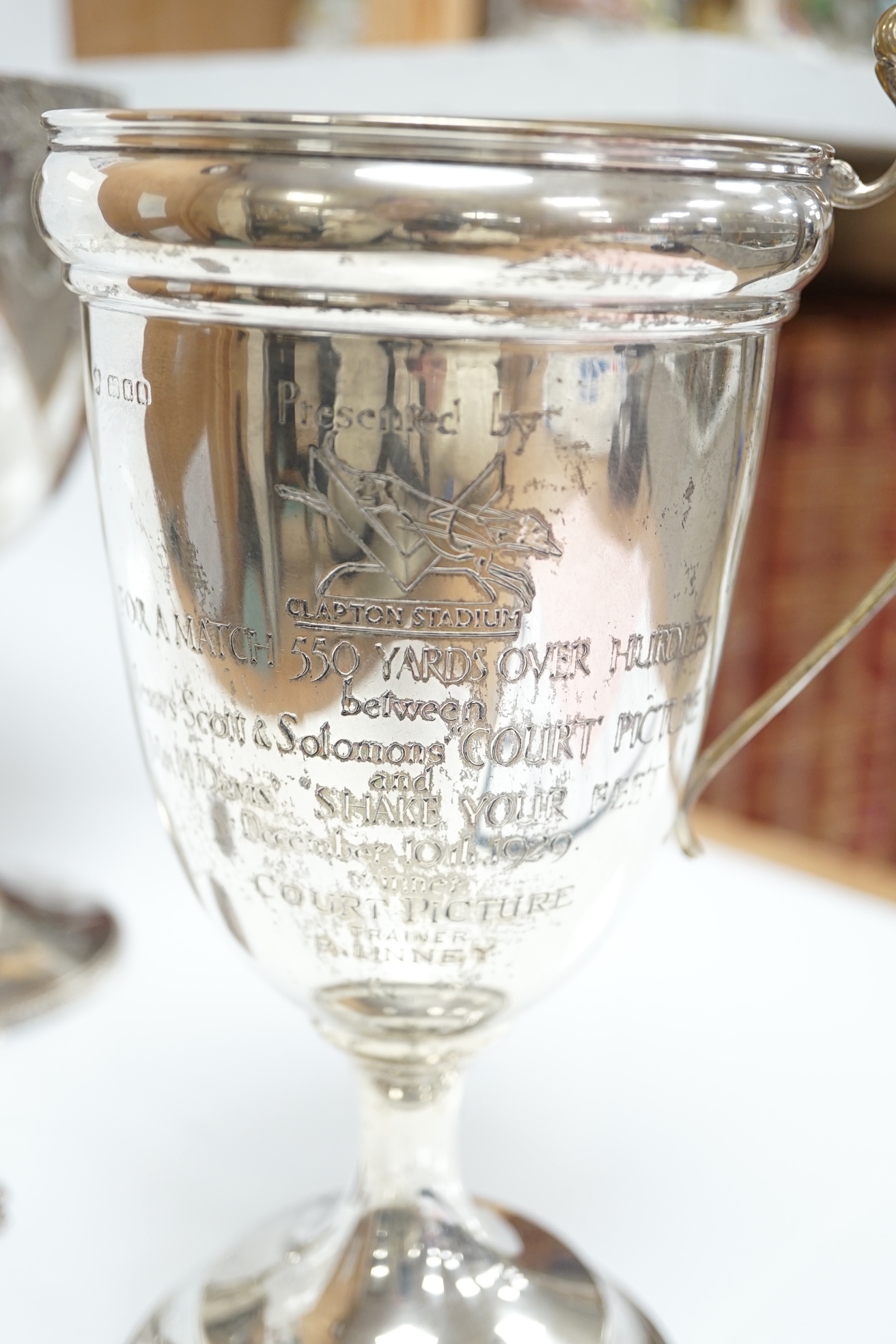 A Victorian engraved silver goblet, by Robert Harper, London 1871, with later engraved Greyhound Racing Association Ltd presentation inscription, 23.1cm, one other damaged silver trophy cup and two modern silver wine lab